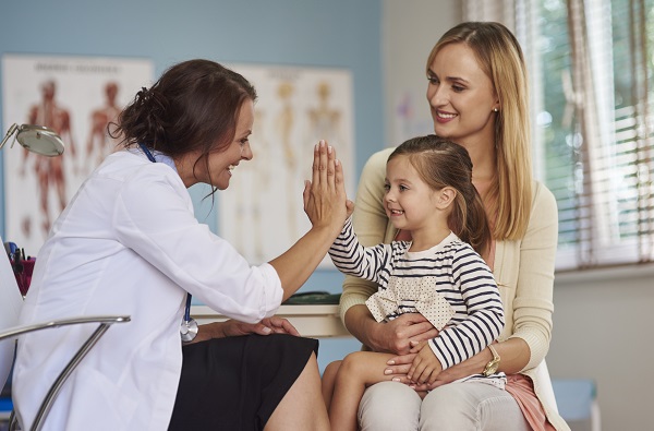 Child with doctor using Employee Benefits insurance